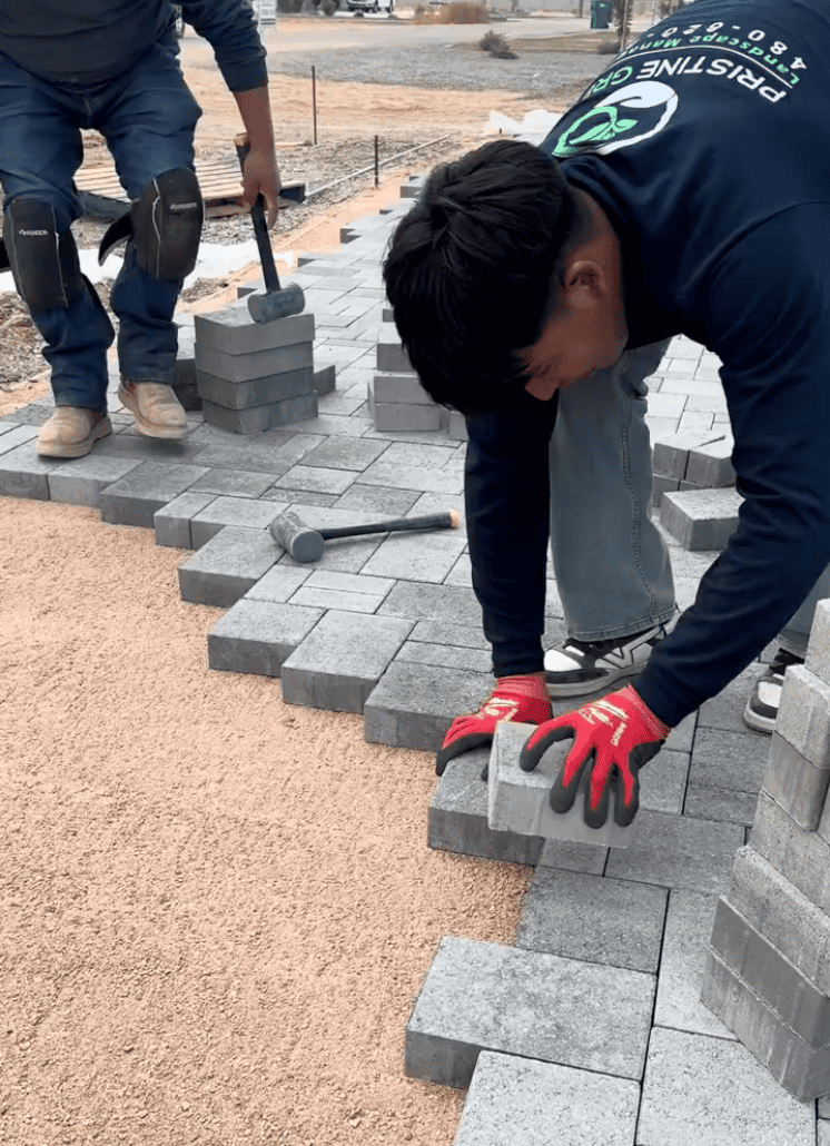 Pavers being installed individually over a prepared Arizona landscape base